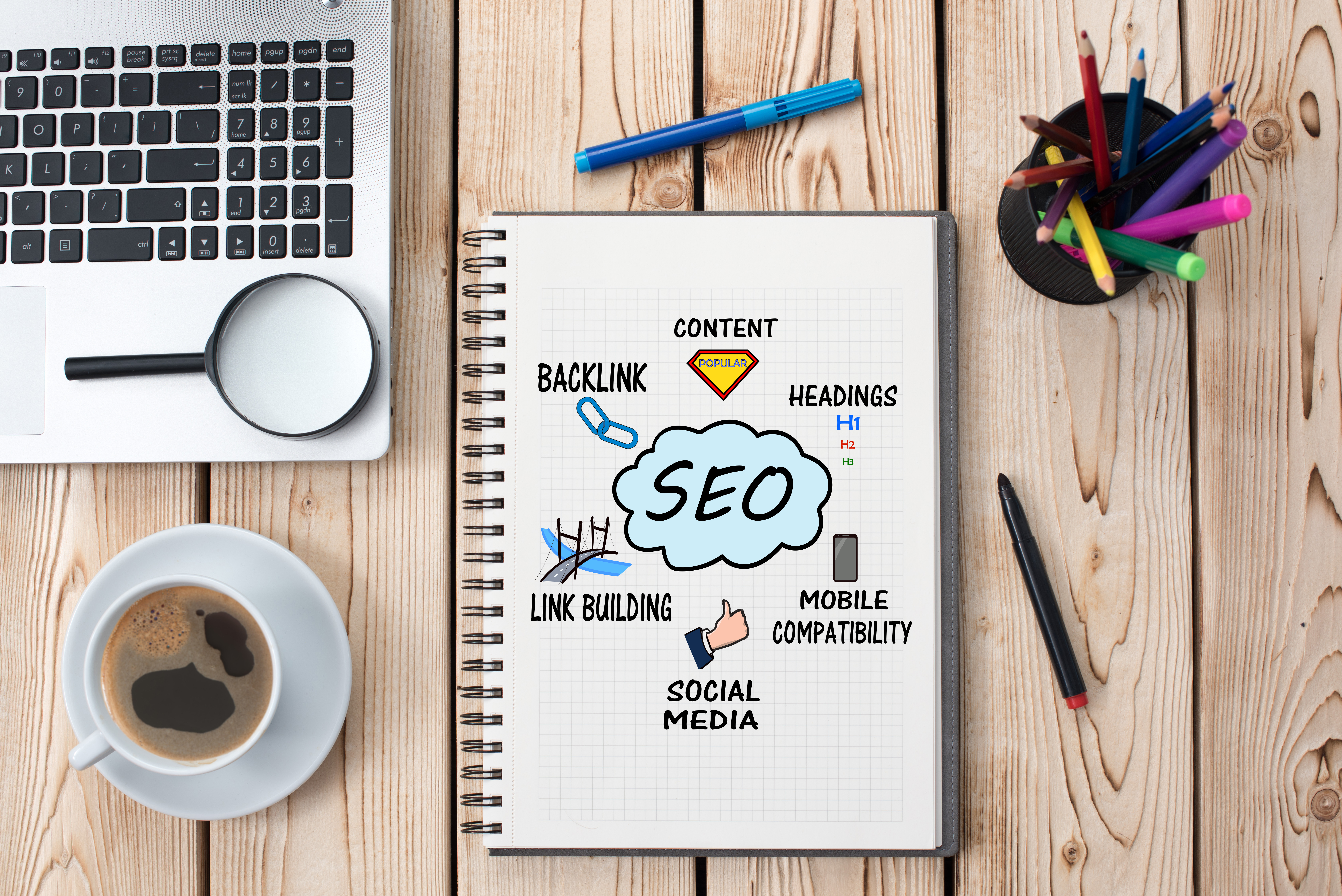 Work desk with a notepad displaying a SEO brainstorming drawing